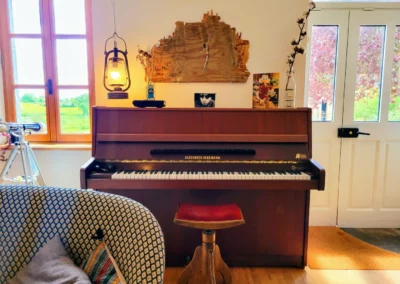 Piano dans le salon de La Maison Folia, maison d’hôtes en Normandie